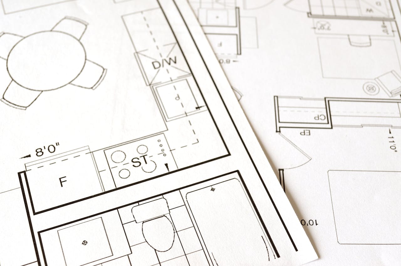 Crafting Captivating Headlines: Your awesome post title goes here Close-up view of an architectural floor plan on paper showcasing detailed room layouts and measurements.