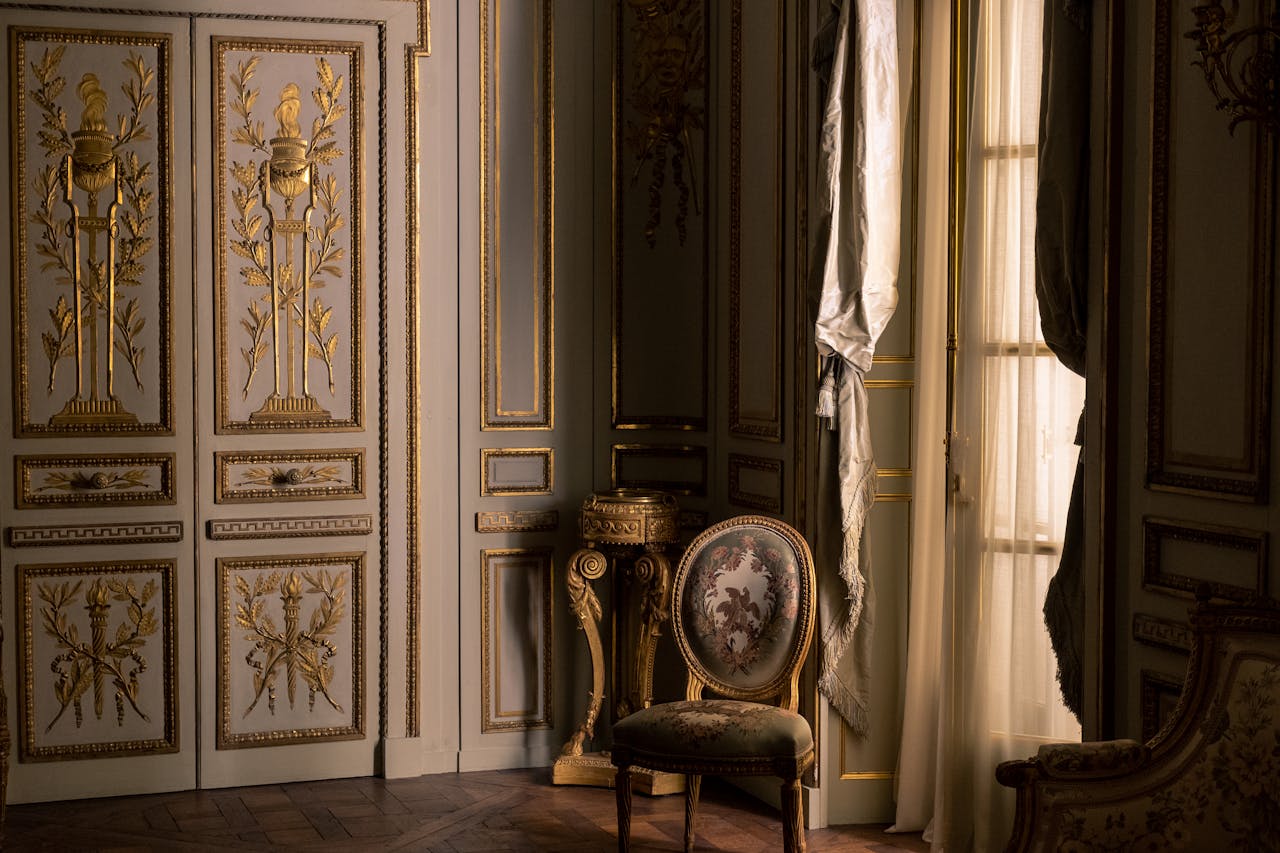 Luxurious interior featuring ornate gold design and classic furniture in a regal setting.